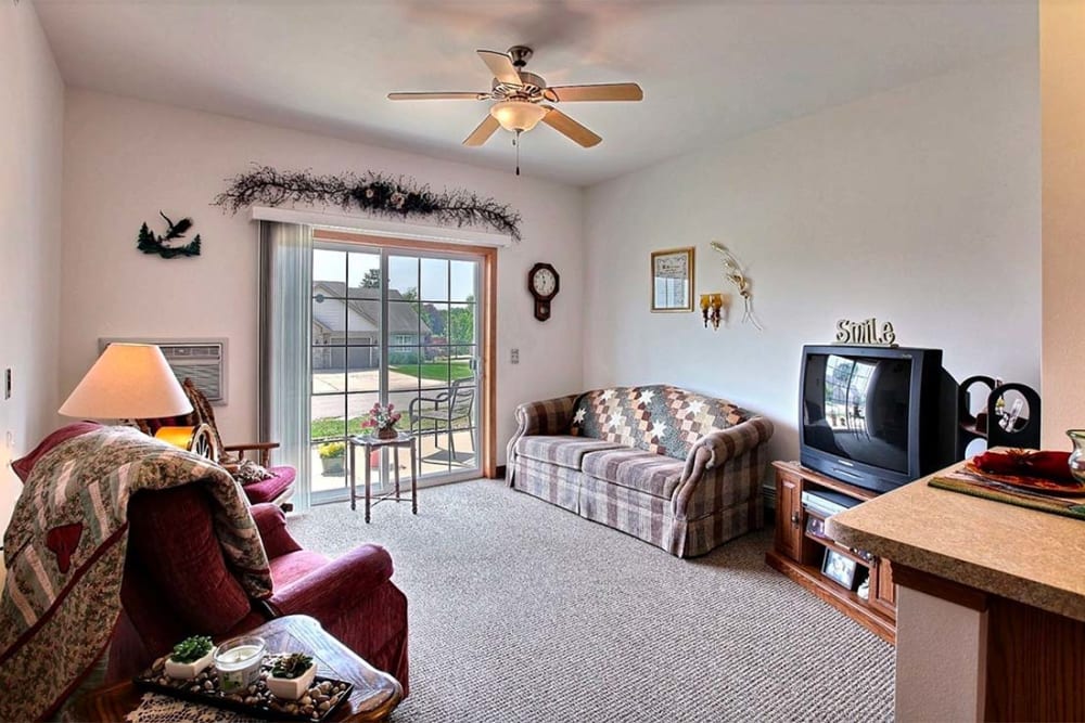 Resident living room with large windows at Milestone Senior Living Hillsboro in Hillsboro, Wisconsin. 
