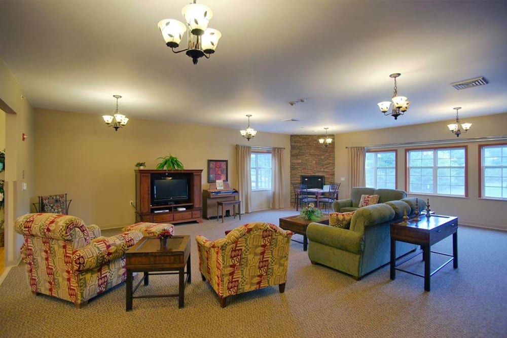 Community room with TV and large windows at Milestone Senior Living Rhinelander in Rhinelander, Wisconsin.