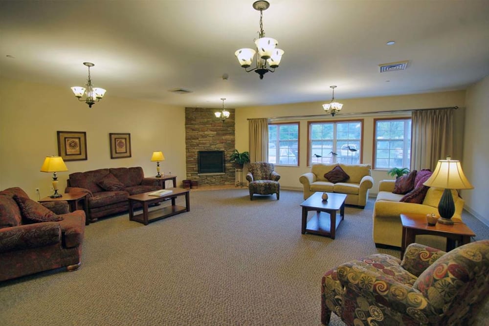 Spacious seating area with large windows at Milestone Senior Living Rhinelander in Rhinelander, Wisconsin.