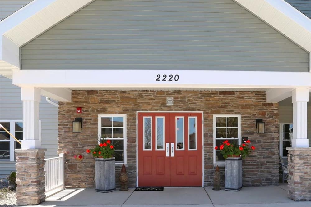 Exterior view of covered main entrance at Milestone Senior Living Stoughton in Stoughton, Wisconsin. 