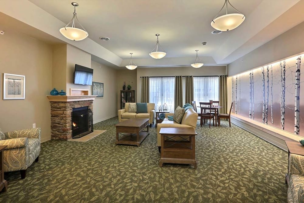 Activity room with TV and fireplace Milestone Senior Living Stoughton in Stoughton, Wisconsin.