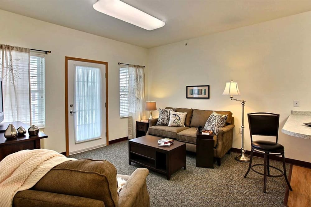 Resident living room with large windows at Milestone Senior Living Woodruff in Woodruff, Wisconsin.