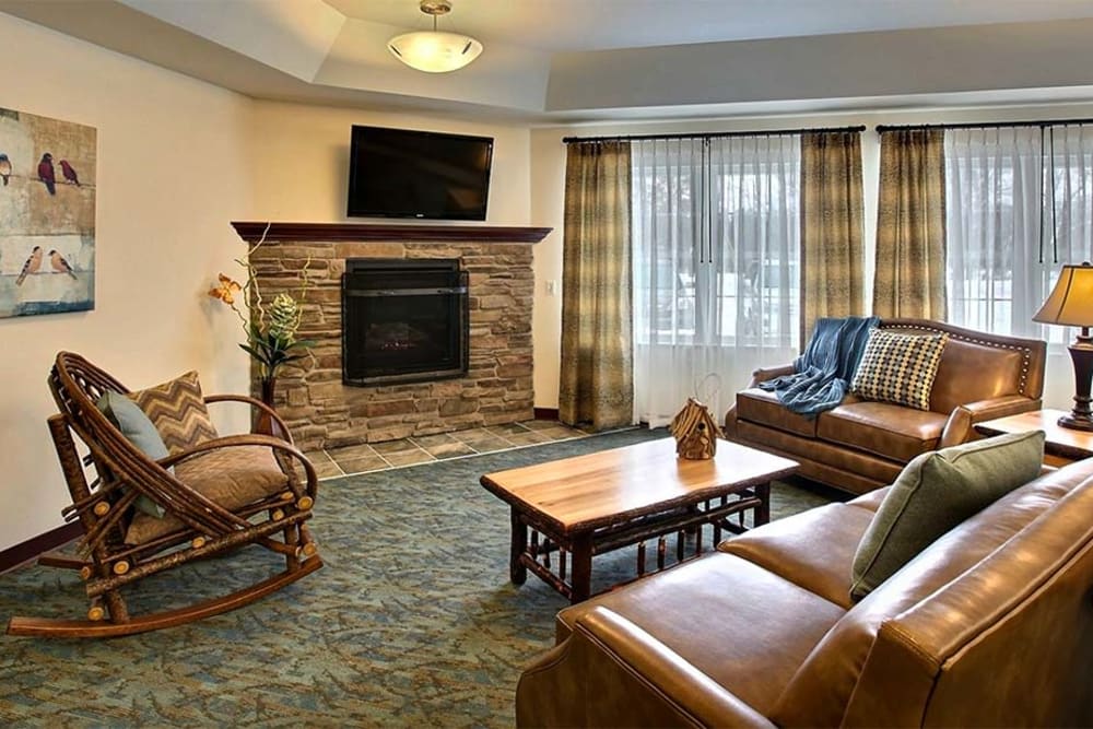 Common room with TV and fireplace at Milestone Senior Living Woodruff in Woodruff, Wisconsin.