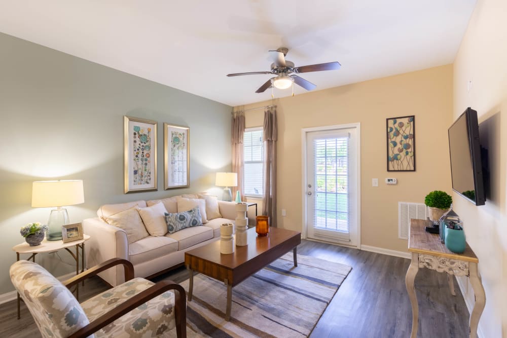 Ceiling fan and and modern furnishings in a model home's living room at Legends at White Oak in Ooltewah, Tennessee