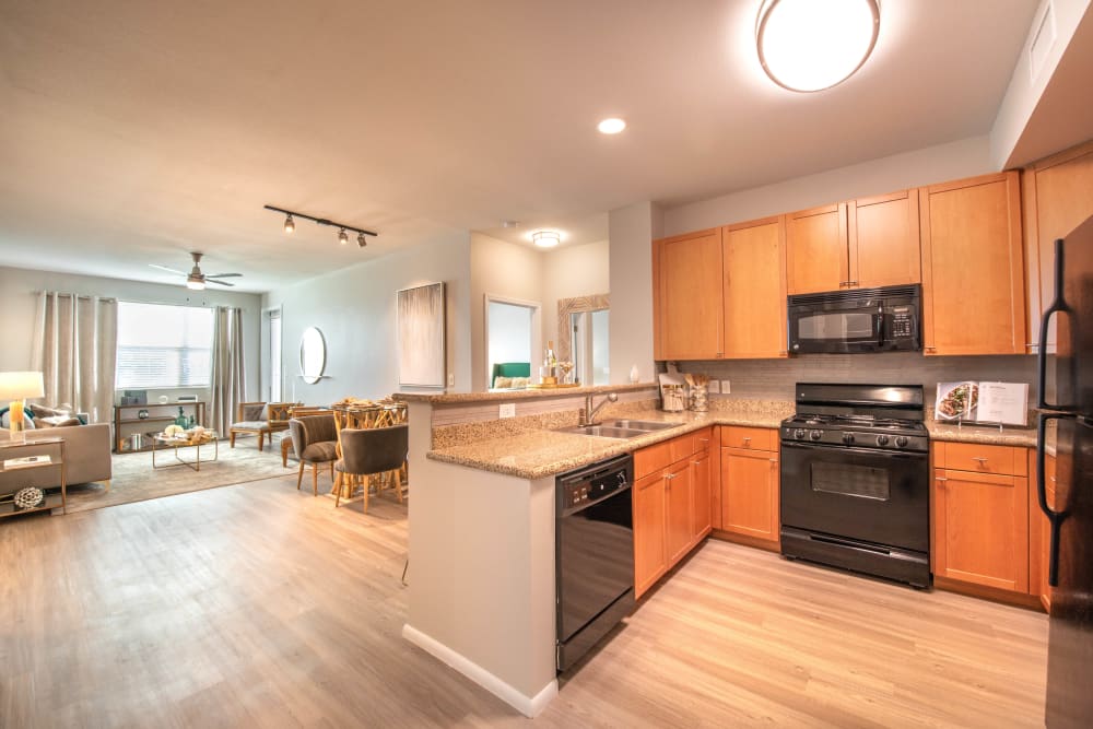 Gourmet kitchen with granite countertops in a model apartment at Olympus at Daybreak in South Jordan, Utah