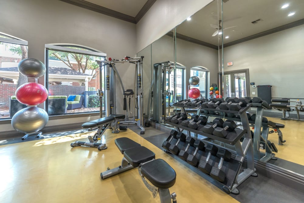 Weights in the gym at Olympus 7th Street Station in Fort Worth, Texas