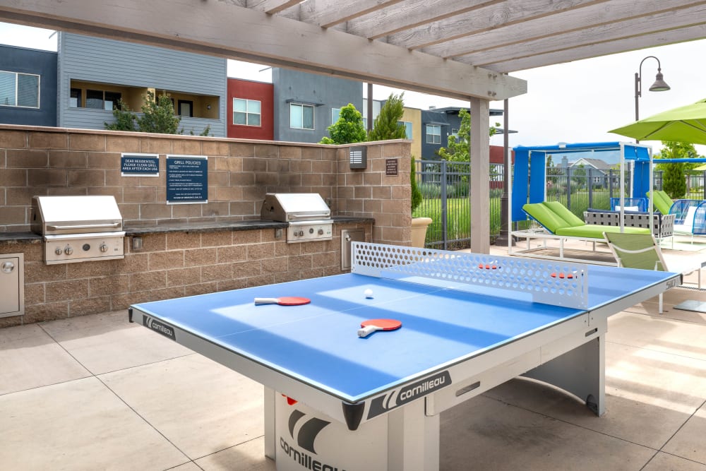 Ping pong table near the barbecue area with gas grills at Olympus at Daybreak in South Jordan, Utah