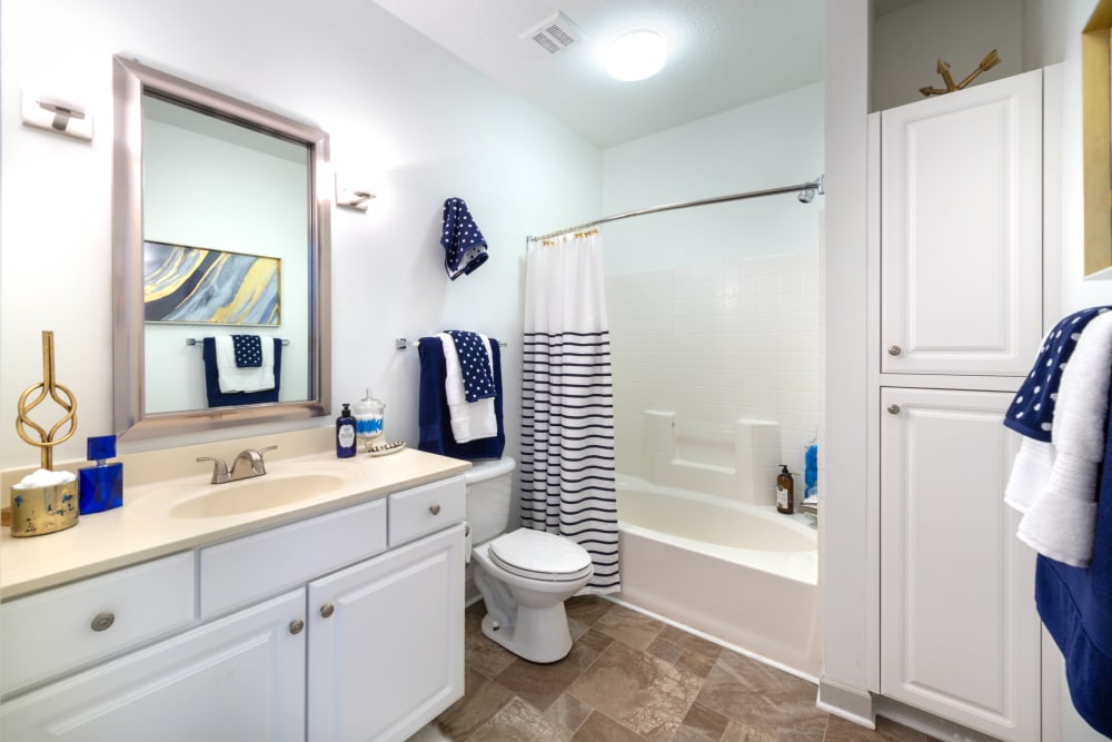 Tiled shower and tiled floor in a model home's bathroom at Olympus Carrington in Pooler, Georgia