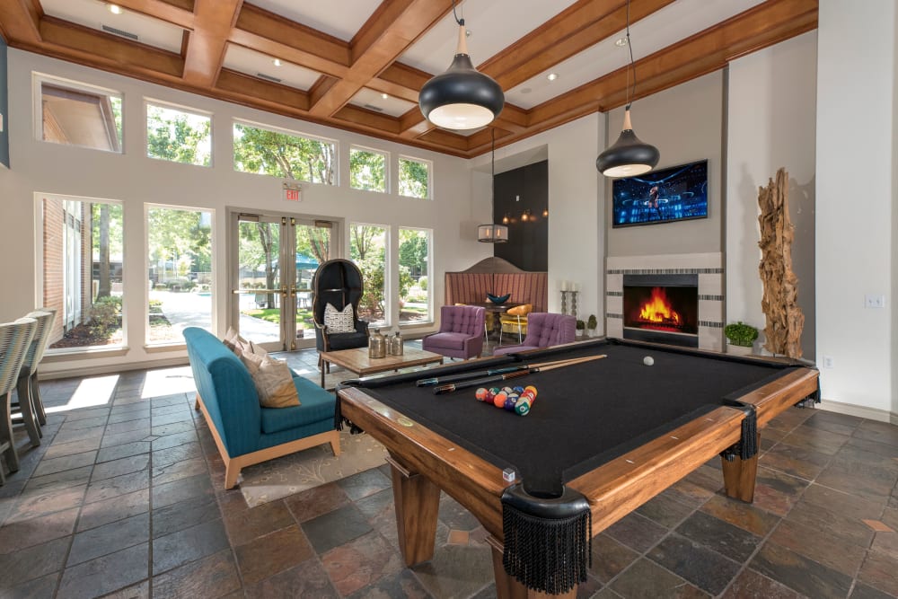 Clubhouse with a large billiards table and a flat-screen TV at Cortland Village Apartment Homes in Hillsboro, Oregon