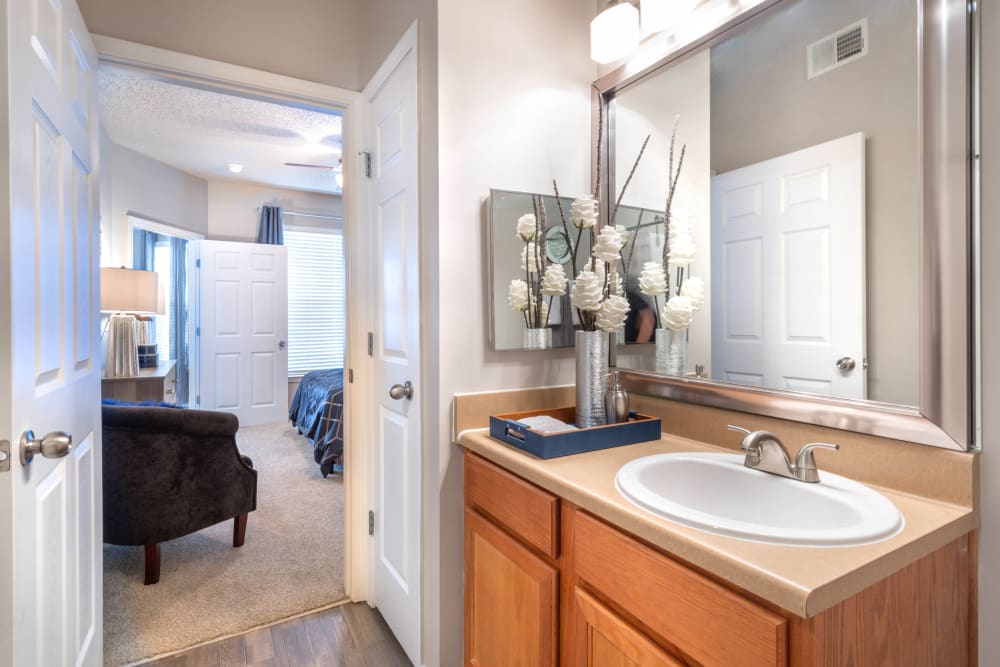 Guest bathroom with a large vanity mirror in a model apartment at Olympus Fenwick in Savannah, Georgia