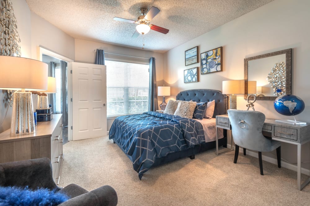 Plush carpeting and a ceiling fan in a model home's primary bedroom at Olympus Fenwick in Savannah, Georgia