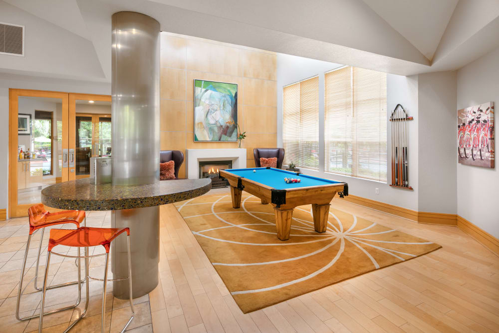 Clubhouse with a billiards table and a fireplace at Center Pointe Apartment Homes in Beaverton, Oregon
