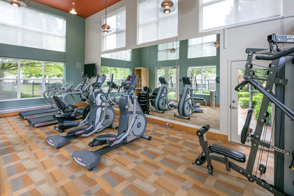 Large fitness center with mirrors at Center Pointe Apartment Homes in Beaverton, Oregon