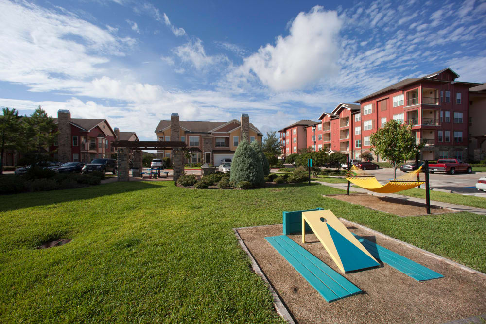 Cornhole court and hammocks at the resident park at Olympus Katy Ranch in Katy, Texas