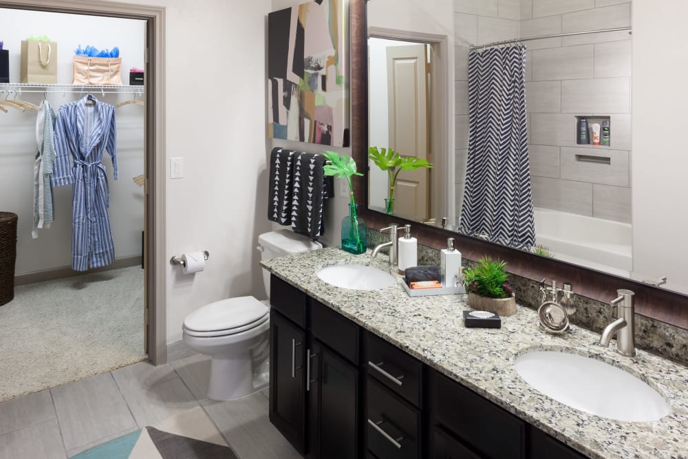 Model home's bathroom with a granite countertop at Olympus Auburn Lakes in Spring, Texas