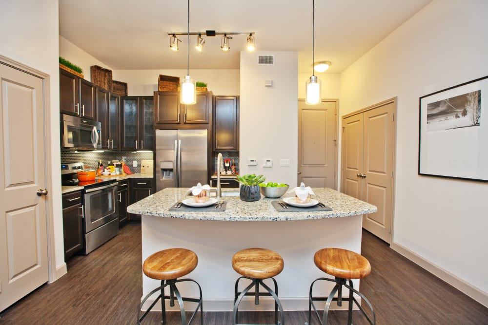 Breakfast bar at the kitchen island in a model apartment at Olympus Auburn Lakes in Spring, Texas