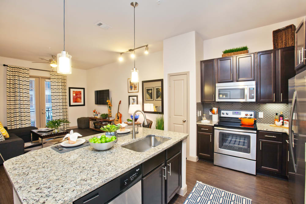 Granite countertops in the kitchen of a model apartment at Olympus Auburn Lakes in Spring, Texas