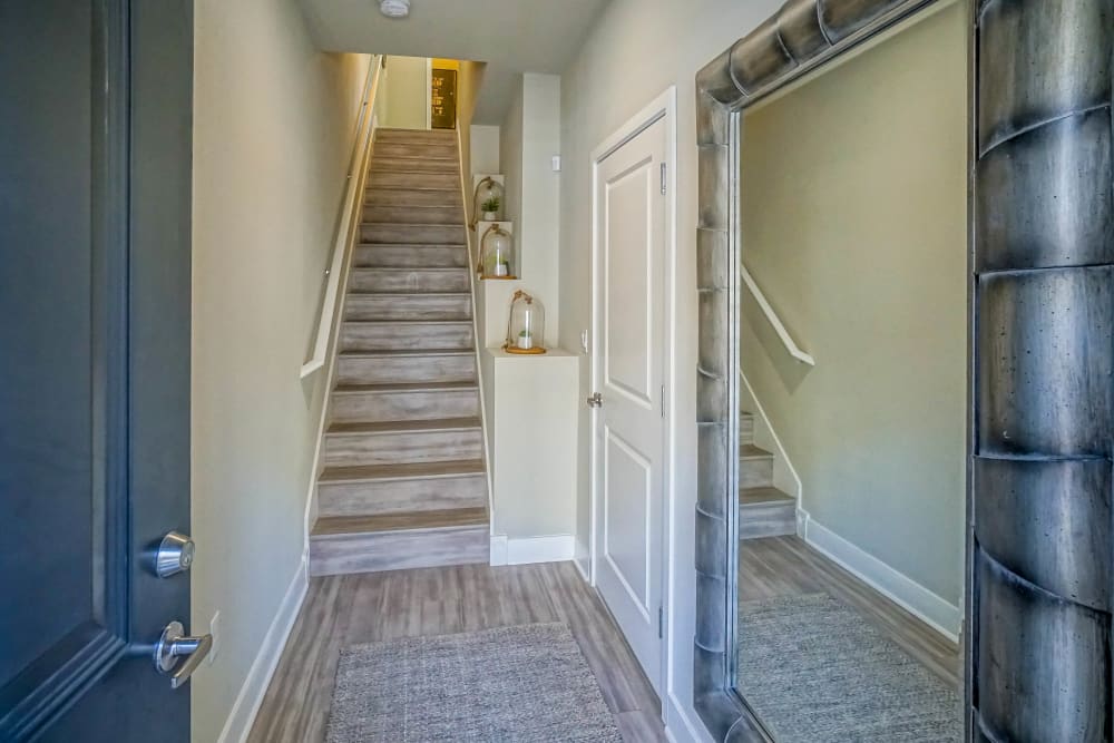 Stairs leading upstairs from the entrance of a model townhome at Olympus Northpoint in Albuquerque, New Mexico