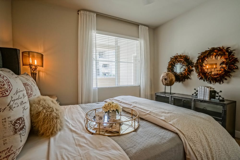 Draped bay window in a model townhome's primary bedroom at Olympus Northpoint in Albuquerque, New Mexico