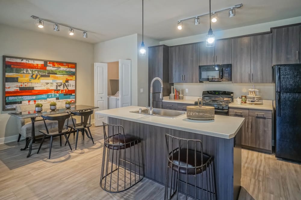 Custom lighting above the kitchen island in a model townhome at Olympus Northpoint in Albuquerque, New Mexico