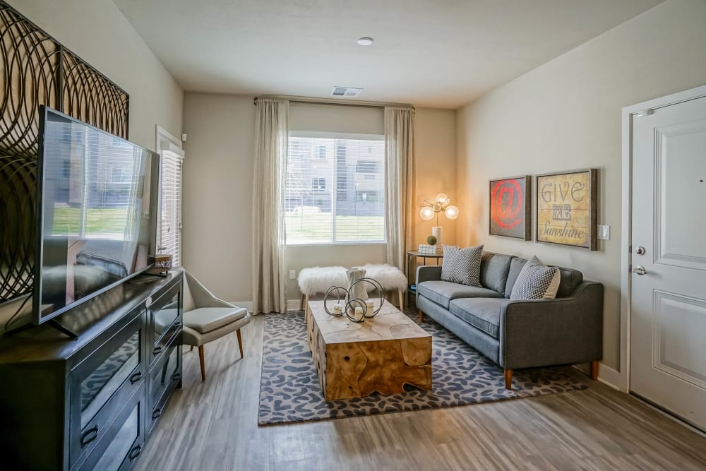 Bay window and hardwood floors in a model apartment's living area at Olympus Northpoint in Albuquerque, New Mexico