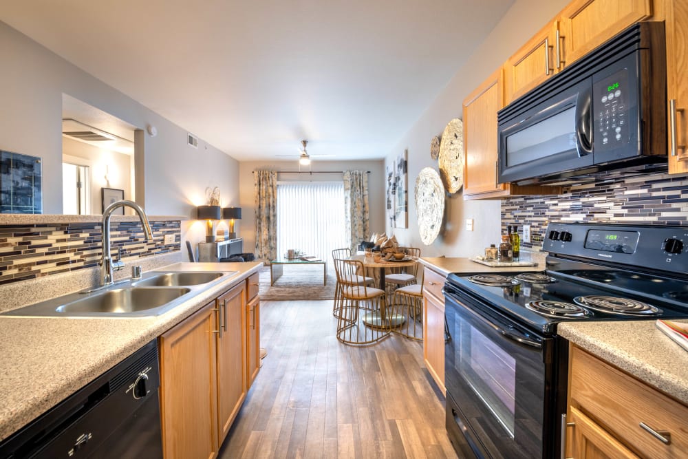 View of the living area from a model home's open-concept gourmet kitchen at Olympus Solaire in Albuquerque, New Mexico
