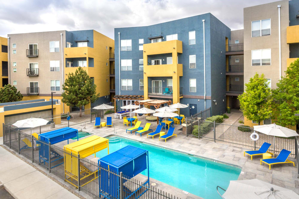 Covered cabanas and lounge chairs around the swimming pool at Olympus Solaire in Albuquerque, New Mexico