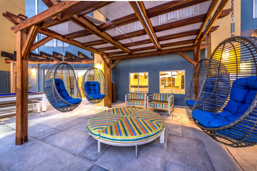 Hanging wicker basket chairs at the outdoor lounge at Olympus Solaire in Albuquerque, New Mexico