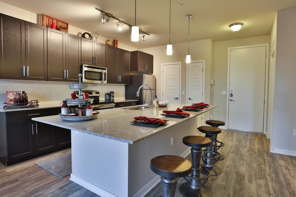 Model apartment's gourmet kitchen with ample cupboard space at Olympus Steelyard in Chandler, Arizona