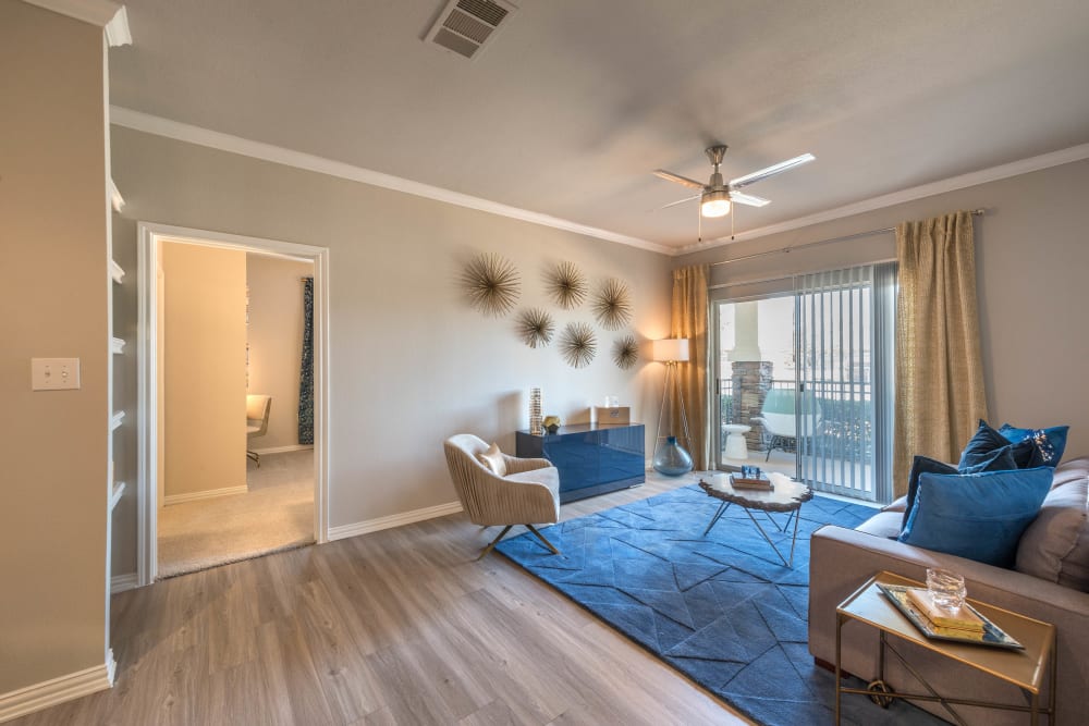 Beautiful hardwood flooring and crown molding in a model home's living areas at Olympus Stone Glen in Keller, Texas