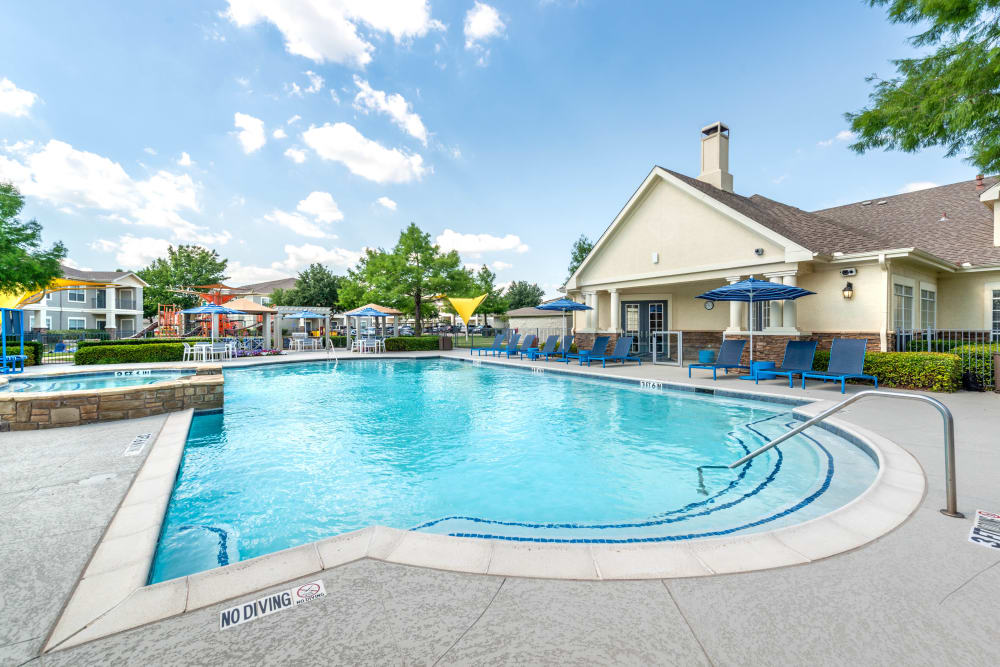 Resort-style swimming pool on a beautiful day at Olympus Stone Glen in Keller, Texas