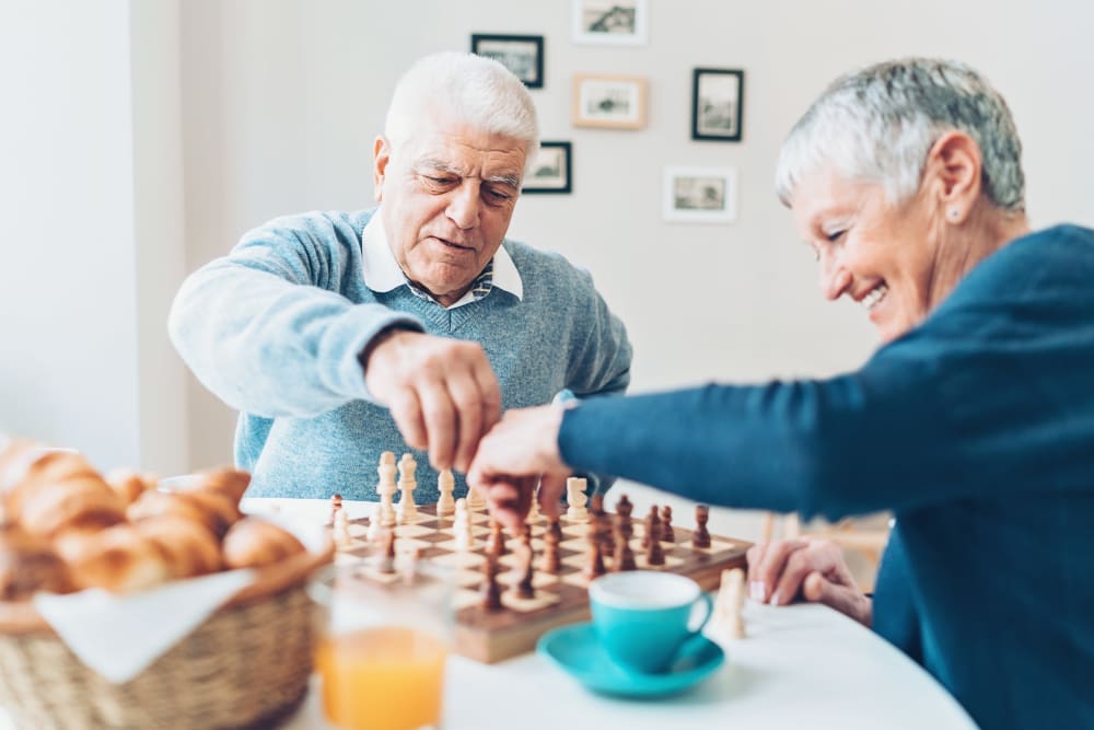 Residents of Keystone Place at Richland Creek enjoying a snack and Chess in O'Fallon, Illinois