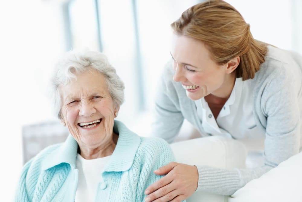 Staff member with resident in assisted living apartment at Milestone Senior Living Eau Claire in Eau Claire, Wisconsin.