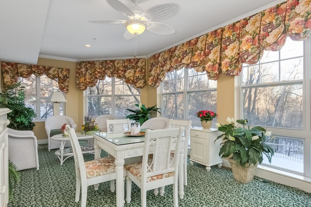 Dining area with large windows at Applewood Pointe of Woodbury in Woodbury, Minnesota. 