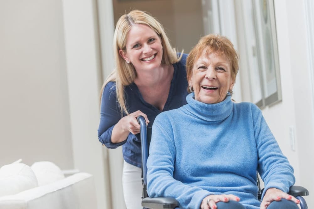 Staff member assists resident in assisted living apartment at Milestone Senior Living Rhinelander in Rhinelander, Wisconsin.