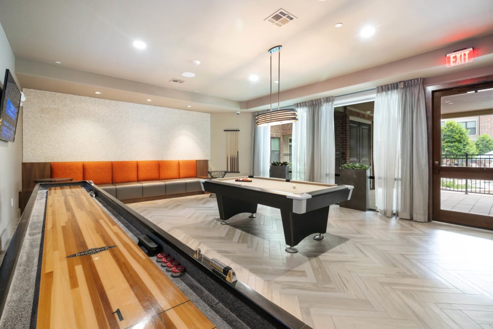 Desktop shuffleboard and billiards in the clubhouse game room at Olympus Sierra Pines in The Woodlands, Texas