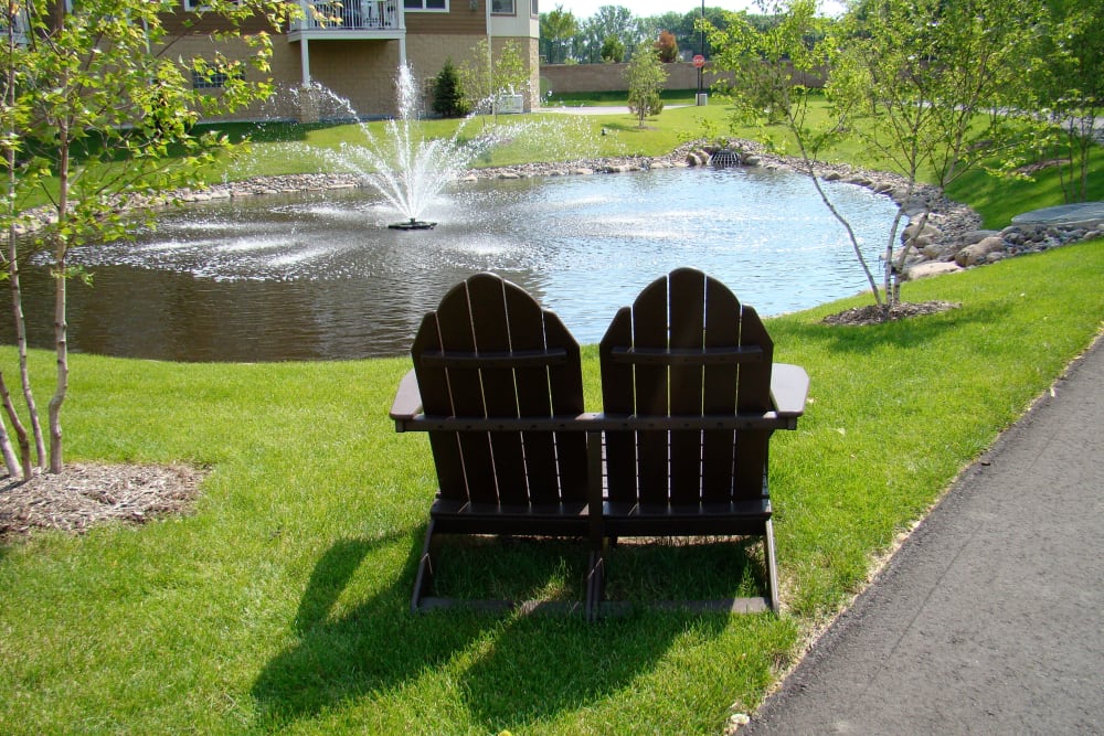 Seats by the pond at Applewood Pointe of Roseville at Langton Lake community in Roseville,  Minnesota. 