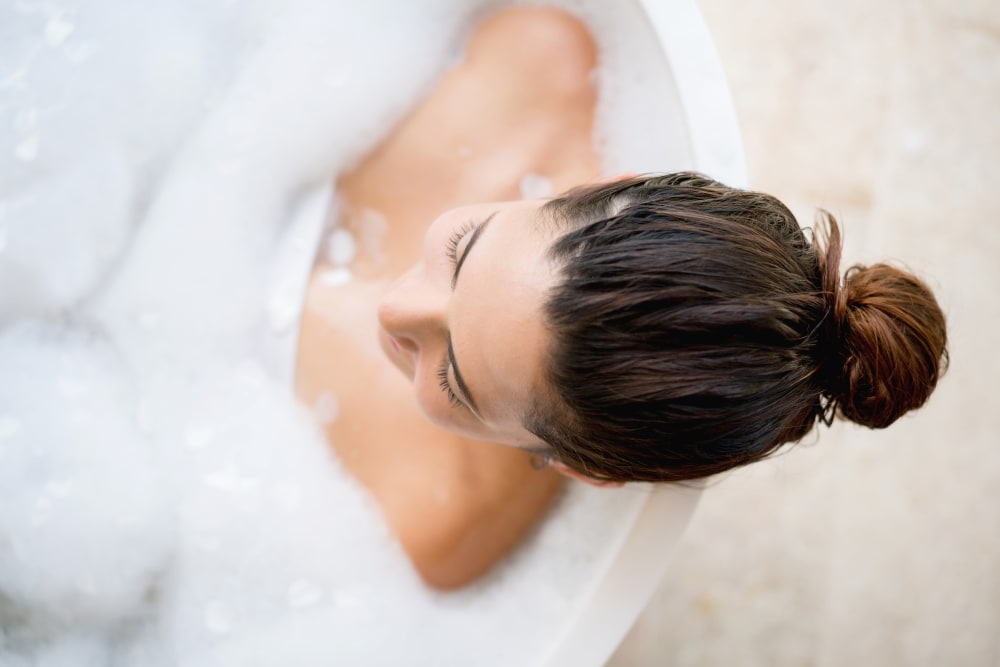 Resident relaxing in a bath at Northgate Crossing in Wheeling, Illinois