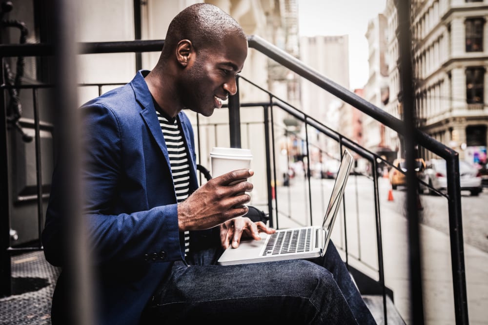 Resident working from his front steps at 21 West Street in New York, New York