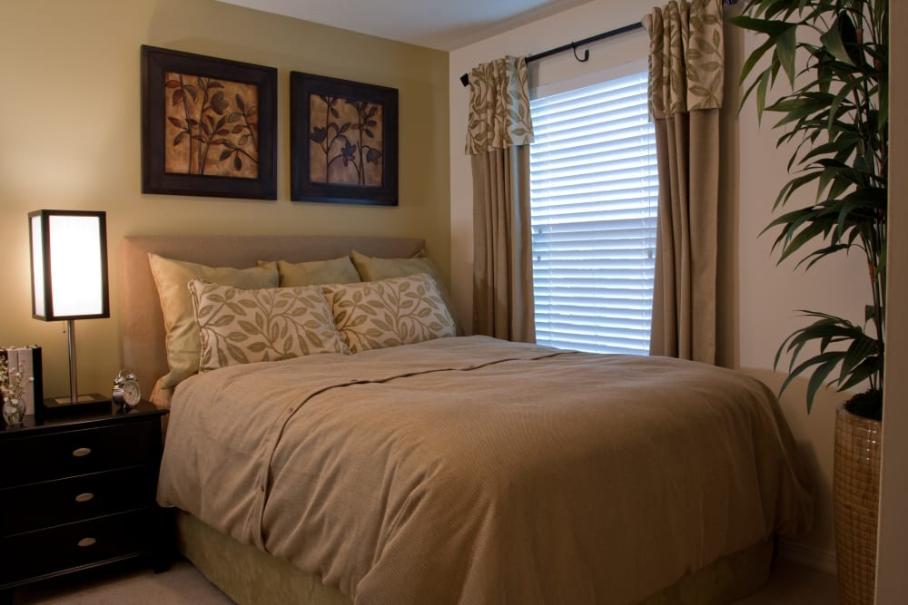 Well-furnished master bedroom in a model home at Abaco Key in Orlando, Florida