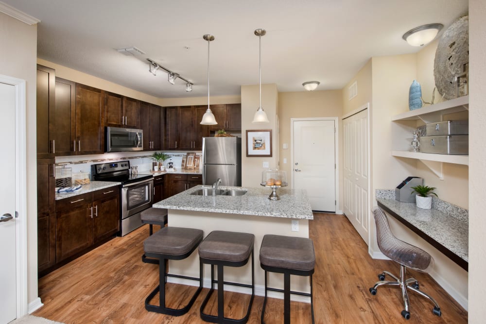 Kitchen with wood style flooring at Integra Lakes in Casselberry, Florida