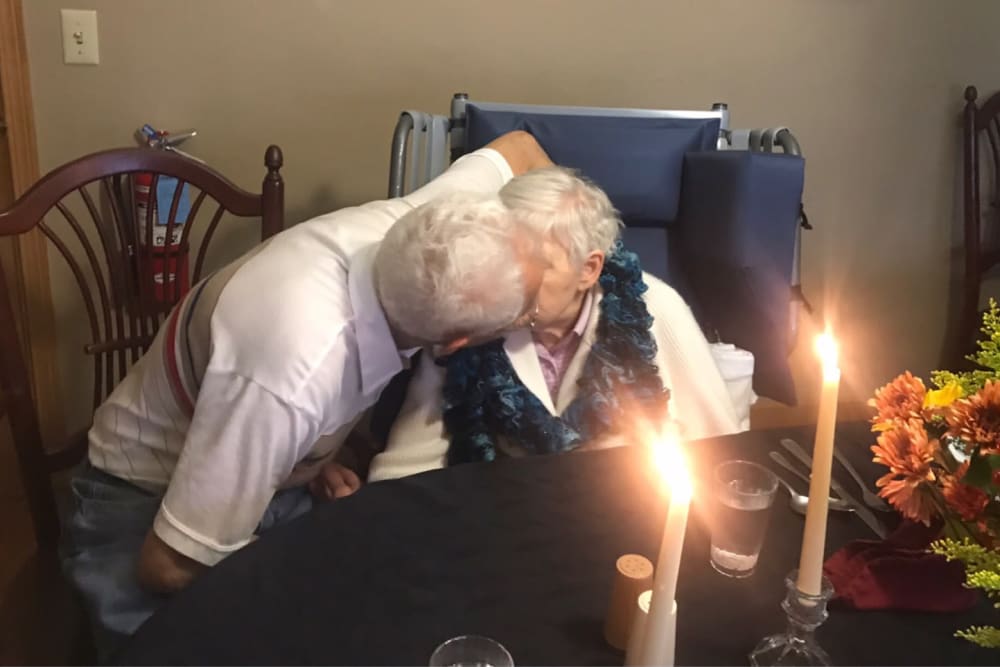 Couple enjoys candlelit Dare to Dream dinner at Ramsey Woods in Cudahy, Wisconsin.