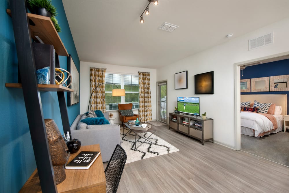 Wood flooring in an apartment living room and bedroom at Linden Crossroads in Orlando, Florida