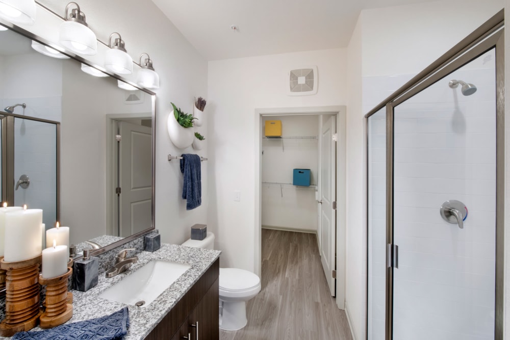 A model bathroom with attached walk-in closet at Linden Crossroads in Orlando, Florida