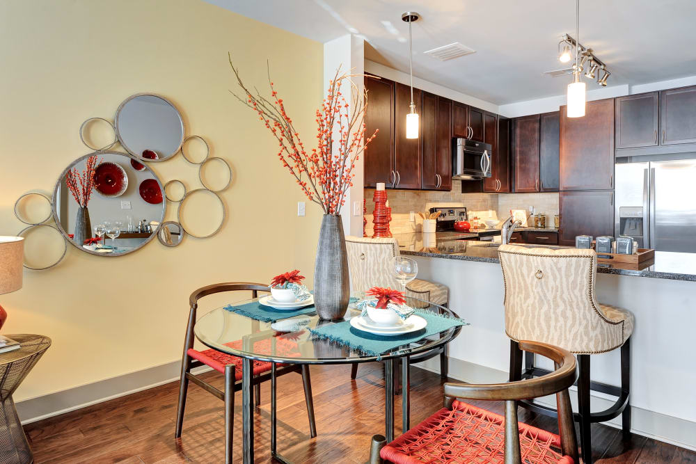 Dining area with a kitchen island at The Mark at Brickyard Apartment Homes in Beltsville, Maryland