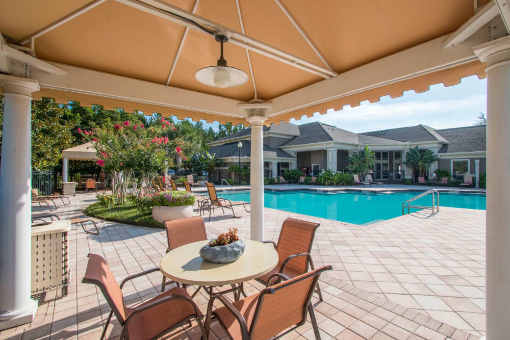 Outdoor dining table by the pool at Landings at Four Corners in Davenport, Florida
