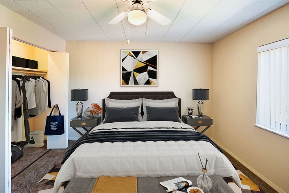 Model bedroom with a ceiling fan and large closet at The Avalon Apartment Homes in Avalon, Pennsylvania