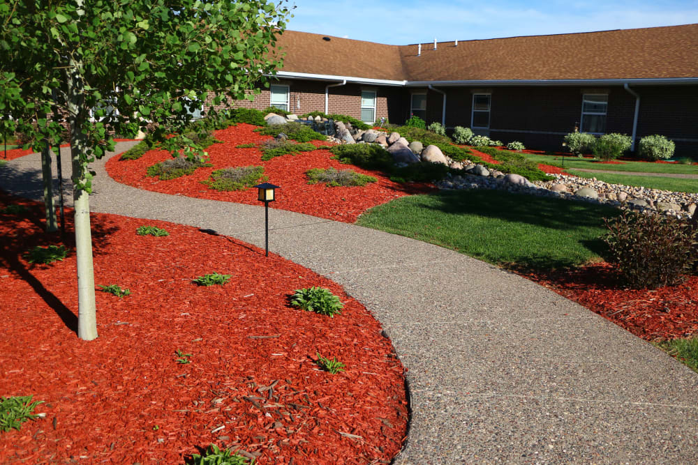 Walking path through lush landscaping at Prairie Hills in Clinton, Iowa.