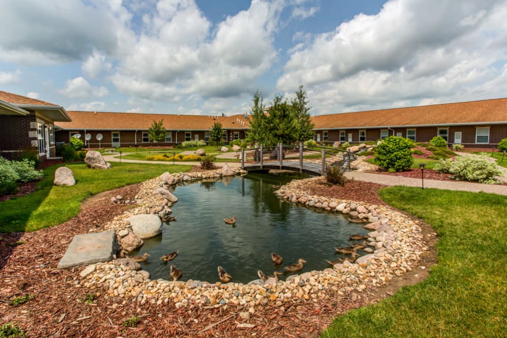 Lush landscaping and pond at Addington Place of Clinton in Clinton, Iowa.
