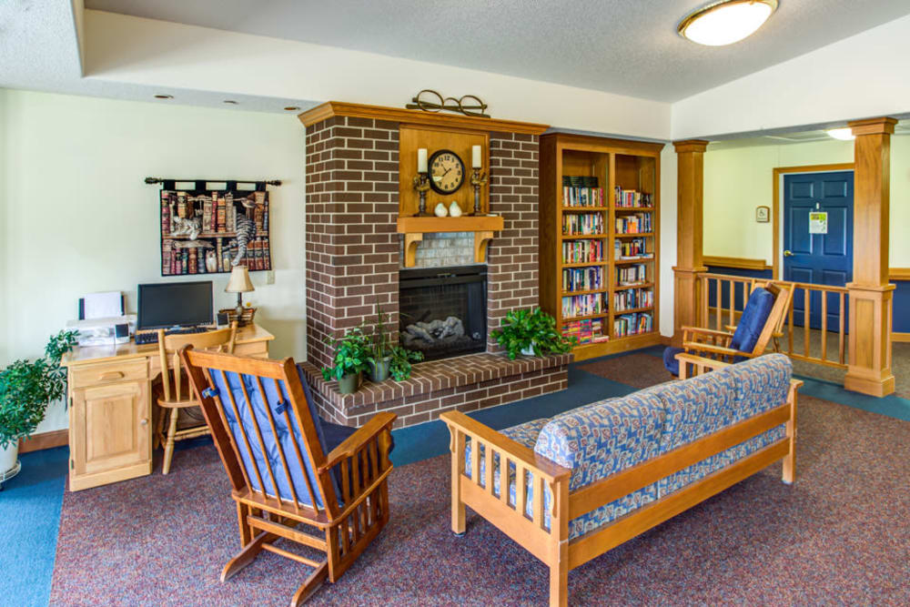 Comfortable lounge seating around a fireplace at Prairie Hills Independence in Independence, Iowa.